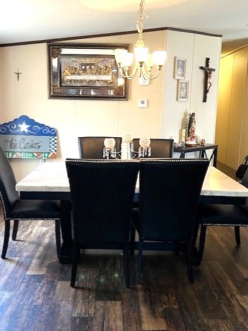 1319 S Broughton Ave, Odessa, TX 79761 - dining area with a chandelier, wood finished floors, and crown molding