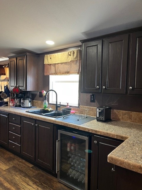 1319 S Broughton Ave, Odessa, TX 79761 - kitchen with a sink, beverage cooler, dark wood finished floors, and light countertops