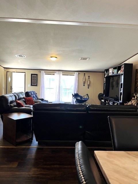 1319 S Broughton Ave, Odessa, TX 79761 - living room featuring healthy amount of natural light and wood finished floors