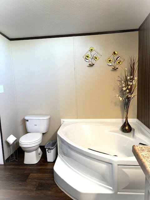 1319 S Broughton Ave, Odessa, TX 79761 - bathroom featuring toilet and wood finished floors
