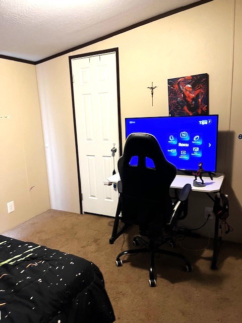 1319 S Broughton Ave, Odessa, TX 79761 - bedroom featuring carpet, ornamental molding, a textured ceiling, and a desk