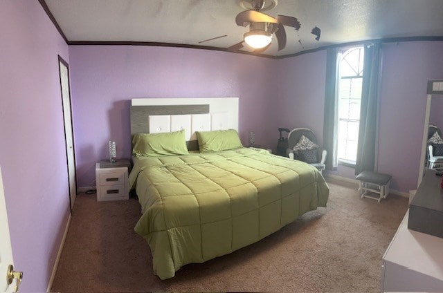 2404 W 10th St, Odessa, TX 79763 - carpeted bedroom with multiple windows, ceiling fan, baseboards, and ornamental molding