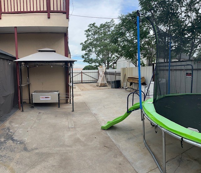2404 W 10th St, Odessa, TX 79763 - fenced backyard featuring a trampoline, a gazebo, and a patio