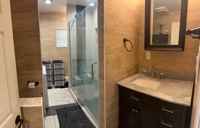 2404 W 10th St, Odessa, TX 79763 - bathroom featuring tile walls, a stall shower, vanity, and recessed lighting