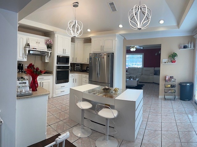 2404 W 10th St, Odessa, TX 79763 - kitchen with stainless steel appliances, a chandelier, recessed lighting, white cabinetry, and under cabinet range hood