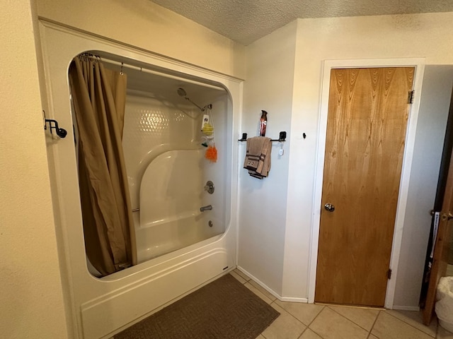 bathroom featuring tile patterned floors, shower / bath combo with shower curtain, and a textured ceiling