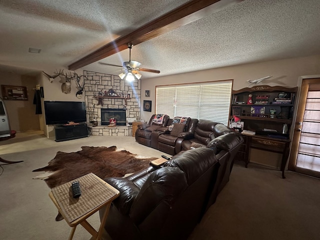 carpeted living room featuring beam ceiling, a textured ceiling, a stone fireplace, and ceiling fan