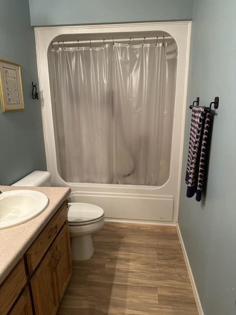 full bathroom featuring toilet, vanity, shower / tub combo, and hardwood / wood-style flooring