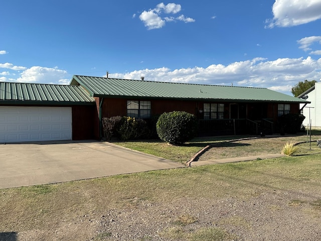 view of front of house with a front yard and a garage