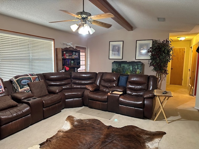 carpeted living room with vaulted ceiling with beams, ceiling fan, and a textured ceiling