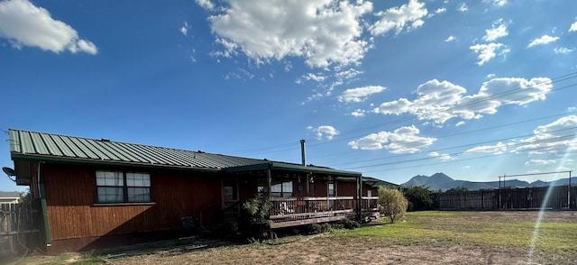 rear view of house featuring a deck with mountain view