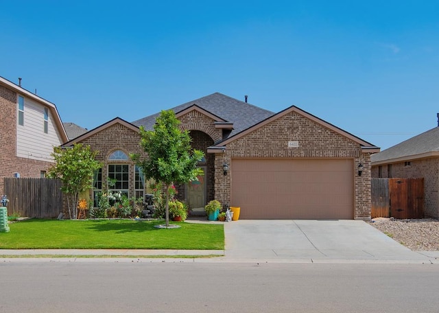 6411 Hall Of Fame, Midland, TX 79706 - view of front of house with brick siding, an attached garage, concrete driveway, and roof with shingles