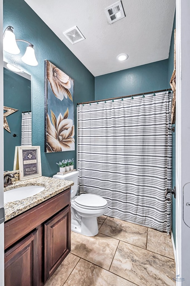 6411 Hall Of Fame, Midland, TX 79706 - full bathroom featuring vanity, toilet, a textured ceiling, a textured wall, and a shower with curtain