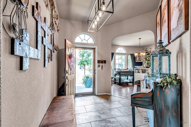 6411 Hall Of Fame, Midland, TX 79706 - foyer with arched walkways and a chandelier