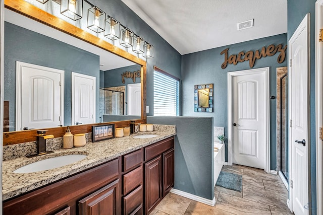 6411 Hall Of Fame, Midland, TX 79706 - bathroom with a shower stall, double vanity, a bath, a textured wall, and baseboards