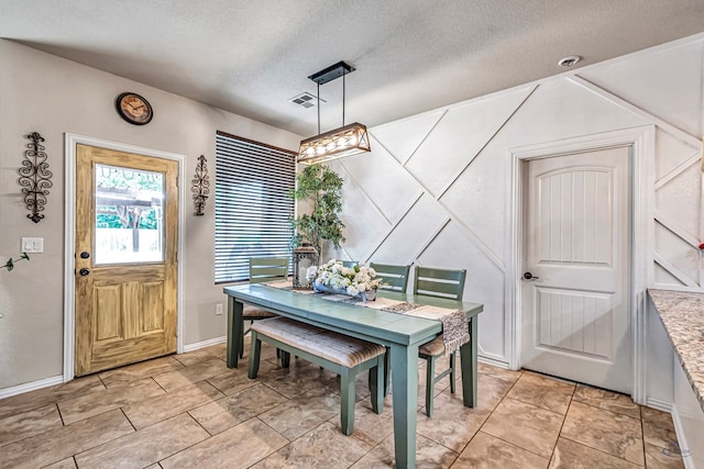6411 Hall Of Fame, Midland, TX 79706 - dining area with a textured ceiling and baseboards