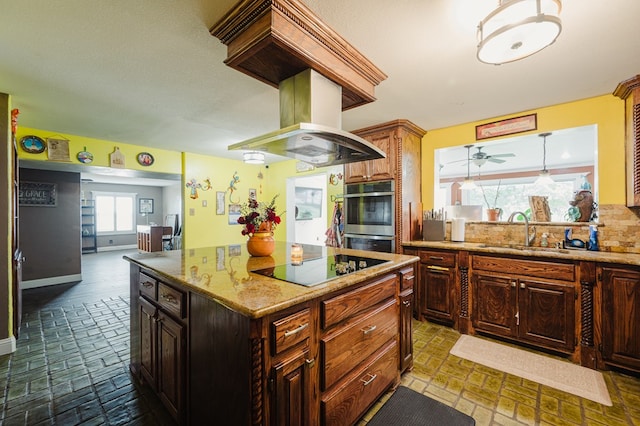 3708 N Moss Ave, Odessa, TX 79764 - kitchen with a sink, black electric cooktop, stainless steel double oven, a kitchen island, and light stone countertops