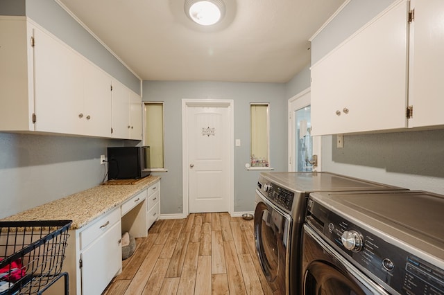3708 N Moss Ave, Odessa, TX 79764 - washroom featuring washing machine and dryer, cabinet space, light wood-type flooring, a desk, and baseboards