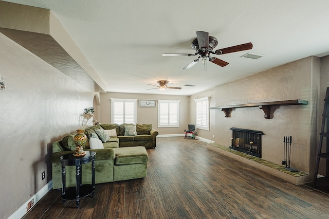 3708 N Moss Ave, Odessa, TX 79764 - living area with a fireplace with raised hearth, a ceiling fan, wood finished floors, and baseboards