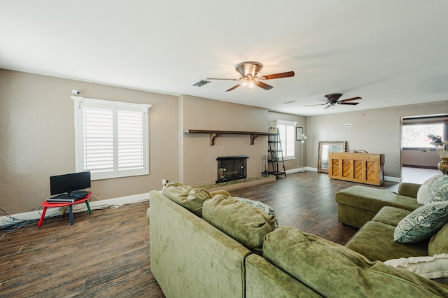 3708 N Moss Ave, Odessa, TX 79764 - living room featuring baseboards, ceiling fan, wood finished floors, and a fireplace with raised hearth