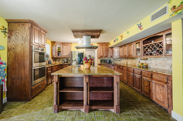 3708 N Moss Ave, Odessa, TX 79764 - kitchen featuring open shelves, stainless steel appliances, island exhaust hood, backsplash, and light stone countertops