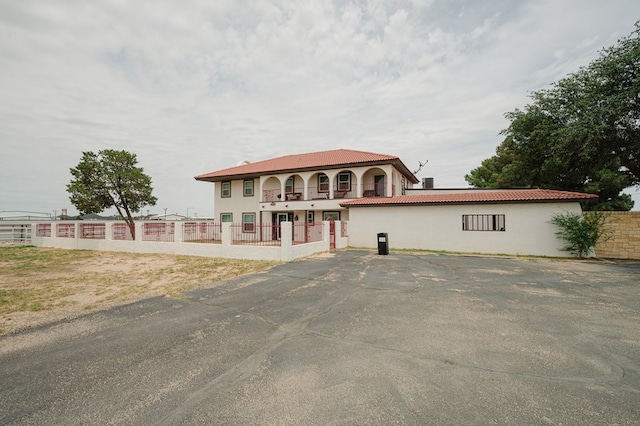 3708 N Moss Ave, Odessa, TX 79764 - mediterranean / spanish home featuring a fenced front yard, stucco siding, and a tile roof