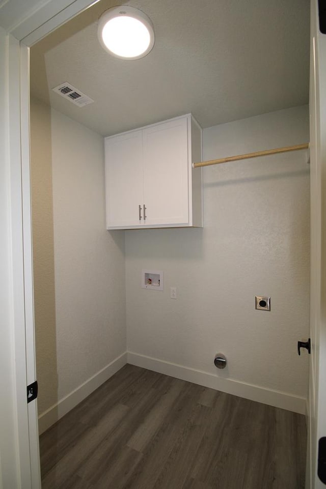 607 NW 11th St, Andrews, TX 79714 - laundry area with hookup for a washing machine, dark wood finished floors, hookup for an electric dryer, and cabinet space