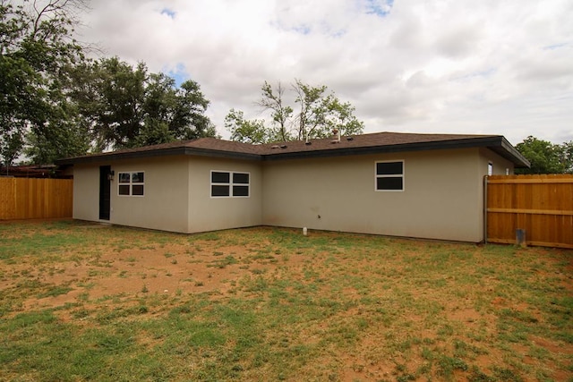 607 NW 11th St, Andrews, TX 79714 - rear view of house with stucco siding