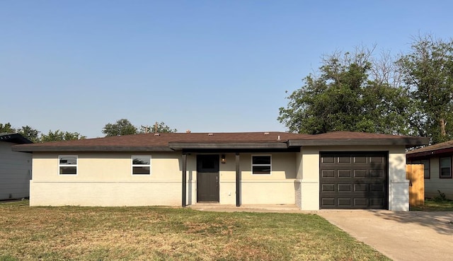 607 NW 11th St, Andrews, TX 79714 - ranch-style house with an attached garage, driveway, a front lawn, and stucco siding