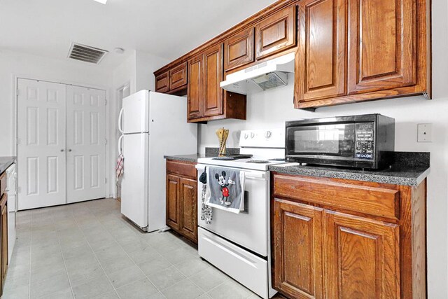1206 Alameda Ave, Odessa, TX 79763 - kitchen featuring white appliances, under cabinet range hood, and brown cabinetry