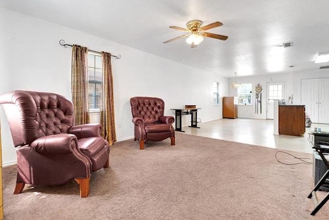 1206 Alameda Ave, Odessa, TX 79763 - living area with ceiling fan, light colored carpet, a chandelier, and baseboards