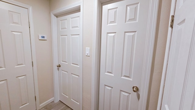 interior details featuring wood finished floors and baseboards