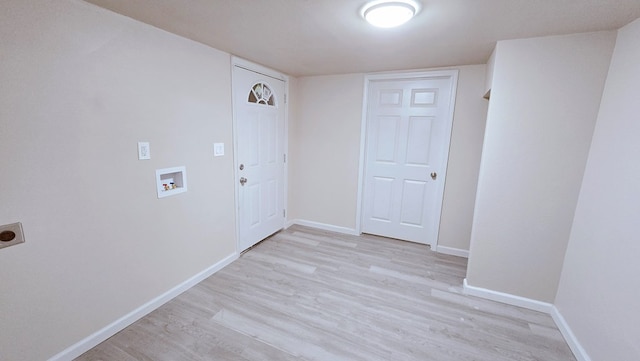 clothes washing area featuring laundry area, baseboards, hookup for a washing machine, hookup for an electric dryer, and light wood-style floors