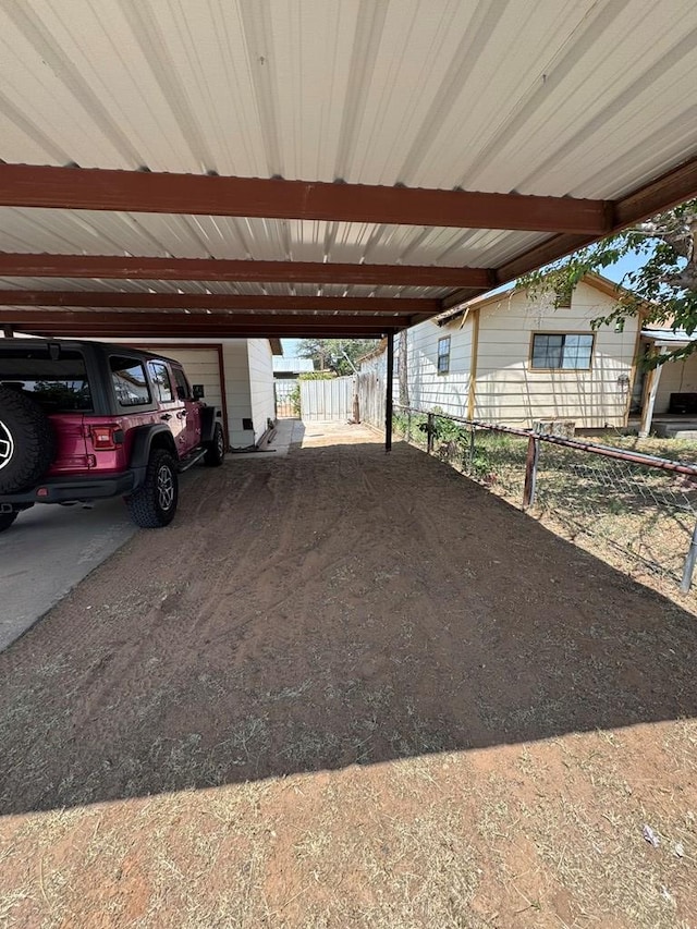 1044 Washington St, Kermit, TX 79745 - view of parking / parking lot featuring a carport and a garage