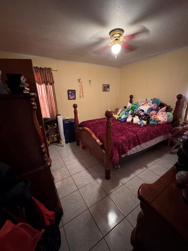 1044 Washington St, Kermit, TX 79745 - bedroom with light tile patterned floors, a textured ceiling, and ceiling fan
