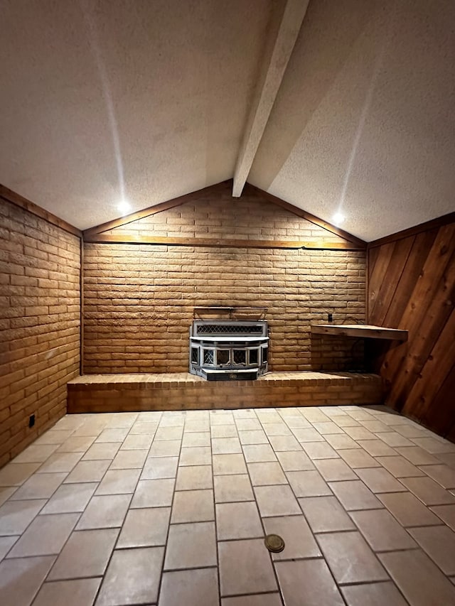 additional living space with vaulted ceiling with beams, a textured ceiling, brick wall, and heating unit