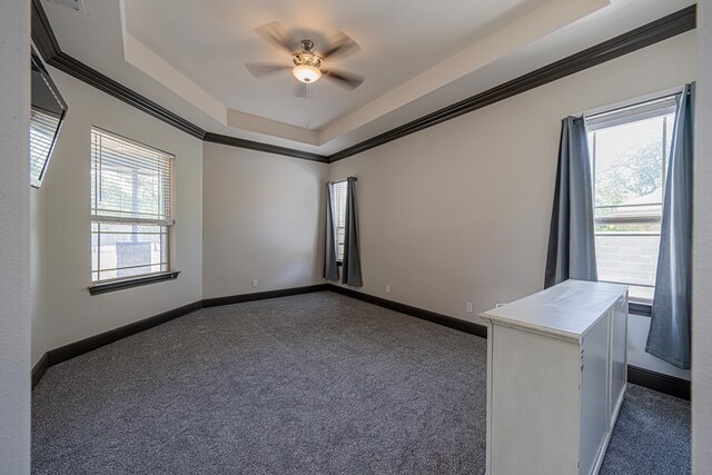 14105 County Rd 122, Odessa, TX 79765 - empty room with dark carpet, a ceiling fan, ornamental molding, and baseboards