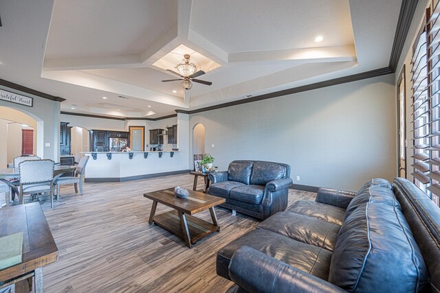 14105 County Rd 122, Odessa, TX 79765 - living area with arched walkways, ceiling fan, a tray ceiling, baseboards, and recessed lighting
