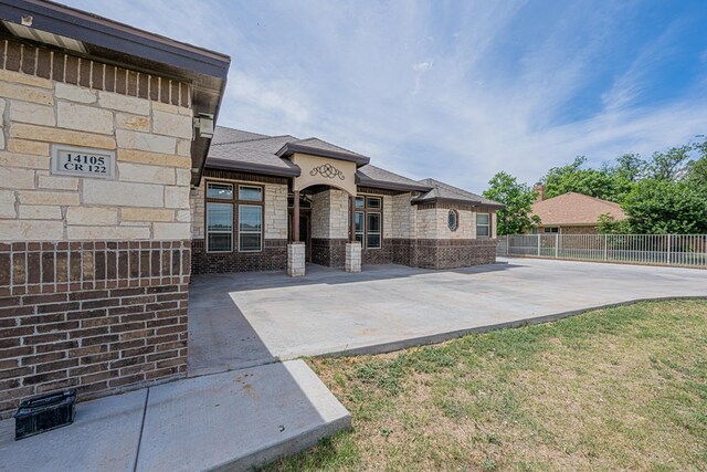 14105 County Rd 122, Odessa, TX 79765 - view of front facade featuring fence and brick siding