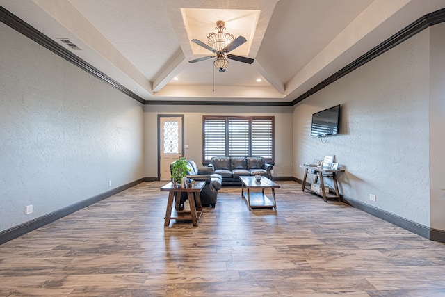 14105 County Rd 122, Odessa, TX 79765 - living room featuring a ceiling fan, wood finished floors, a textured wall, baseboards, and a tray ceiling