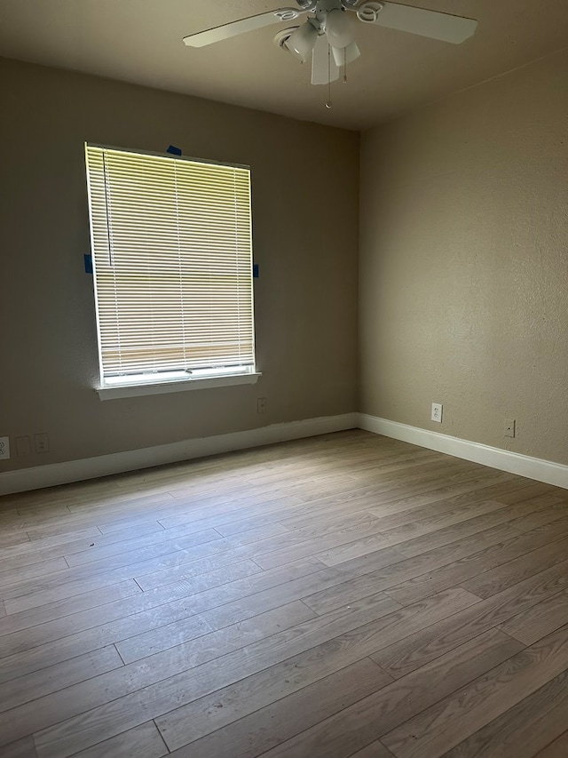 302 E Byrd St, Universal City, TX 78148 - spare room featuring a ceiling fan, wood finished floors, and baseboards