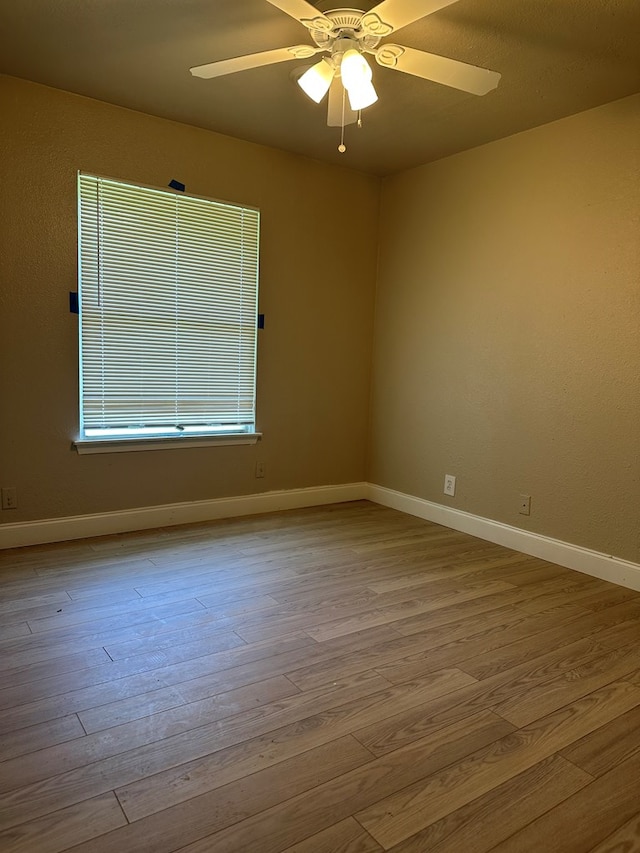 302 E Byrd St, Universal City, TX 78148 - spare room with wood finished floors, a ceiling fan, and baseboards