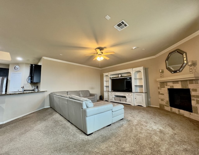 living area with visible vents, ornamental molding, carpet, and ceiling fan
