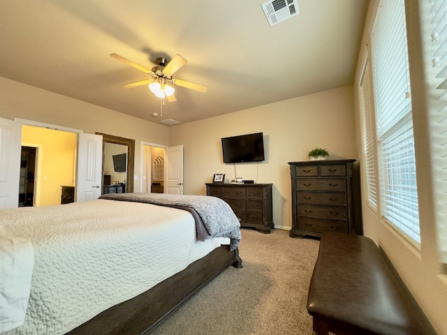 bedroom featuring baseboards, light carpet, a ceiling fan, and visible vents