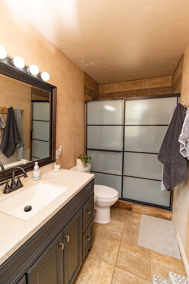 bathroom featuring vanity, walk in shower, and toilet