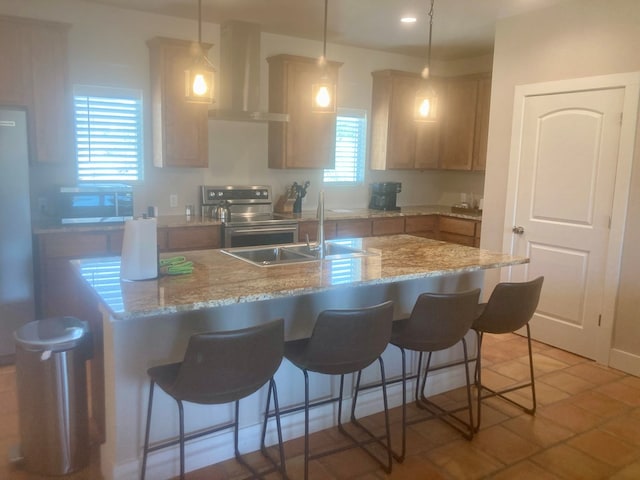 420 Santana Dr, Lajitas, TX 79852 - kitchen with wall chimney range hood, stainless steel range with electric cooktop, an island with sink, a sink, and a kitchen breakfast bar