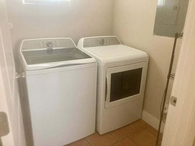 420 Santana Dr, Lajitas, TX 79852 - clothes washing area featuring washing machine and clothes dryer, electric panel, and light tile patterned floors