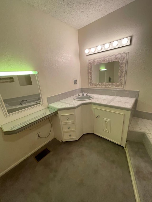 bathroom with vanity and a textured ceiling