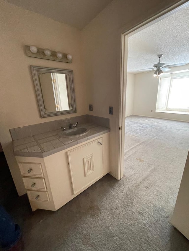 bathroom with vanity, a textured ceiling, and ceiling fan