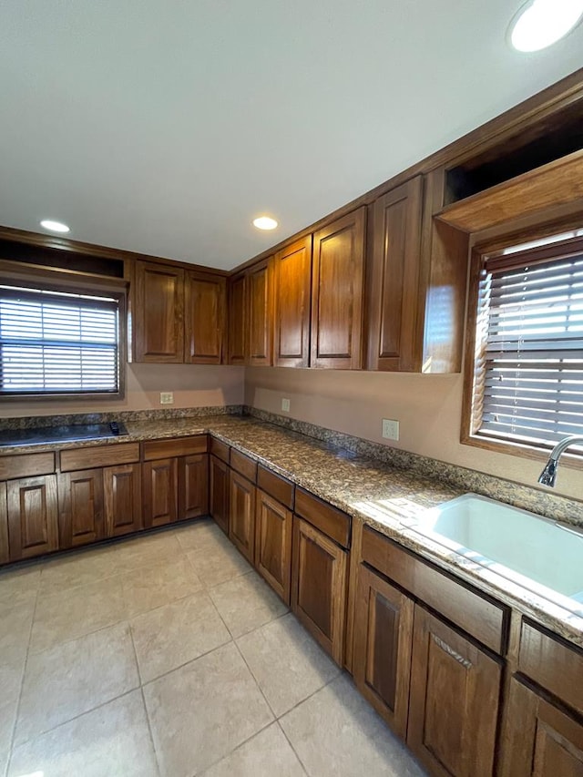 kitchen featuring light tile patterned flooring and sink